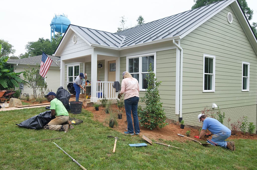 Volunteers and staff landscape the home