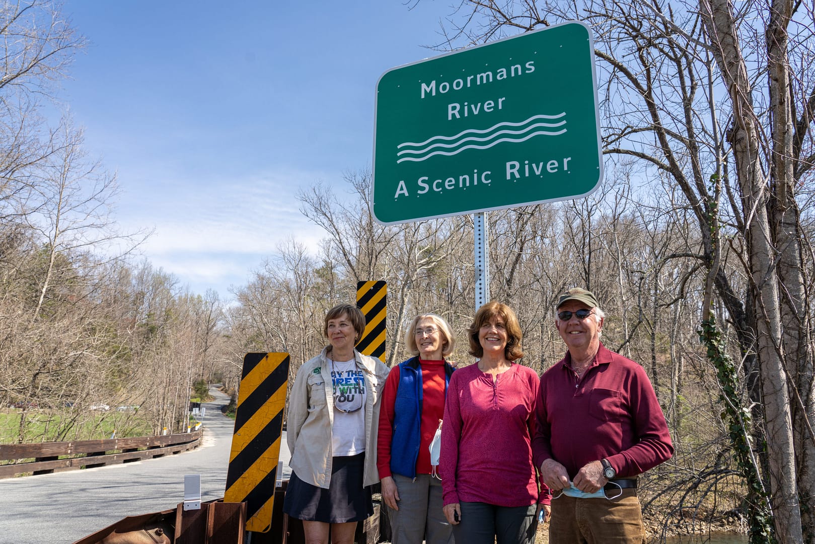 PEC Senior Conservation Fellow Kat Imhoff, Albemarle Supervisors Ann Mallek and Liz Palmer, and PEC board member John Birdsall stand beneath the new Moormans Scenic River sign.