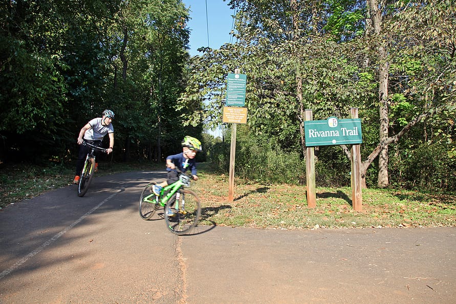 a parent and child bike on the paved Rivanna Trail